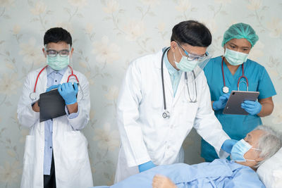 Rear view of doctor examining patient