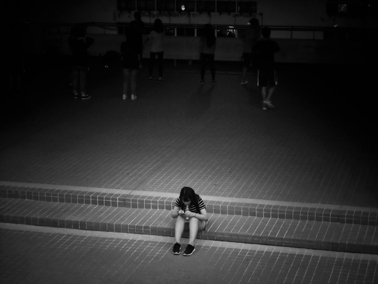 HIGH ANGLE VIEW OF WOMAN WALKING ON SWIMMING POOL