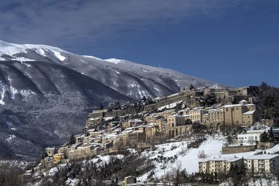 Aerial view of snowcapped mountain against sky