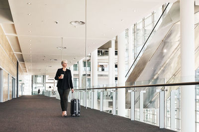 Man walking in corridor of building