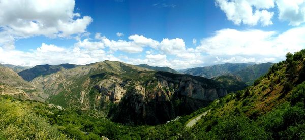 Scenic view of mountains against cloudy sky