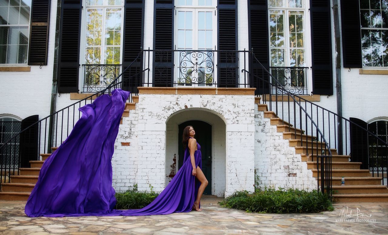 WOMAN STANDING BY BUILDING