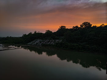 Scenic view of lake against sky at sunset