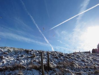 Low angle view of vapor trails in sky