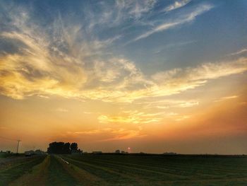 Scenic view of field against sky during sunset