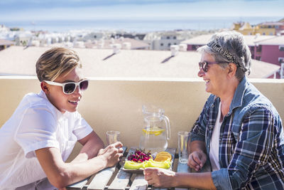 Grandmother and grandson having food at restaurant