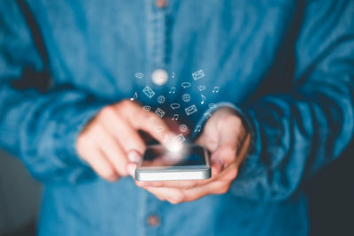 Midsection of woman using mobile phone