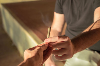 Close-up of man holding cigarette