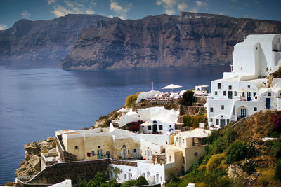 Santorini, greece wide angle aerial shot of cityscape showing white houses built on mountain 