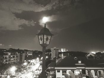 Illuminated buildings against sky at night