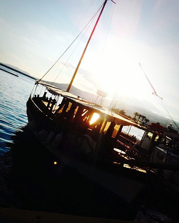 sunbeam, sky, sunlight, sea, sunset, beauty in nature, nautical vessel, outdoors, nature, cloud - sky, sun, water, no people, sailing ship, day, boat deck