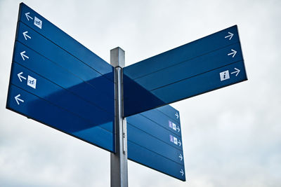 Low angle view of road sign against sky