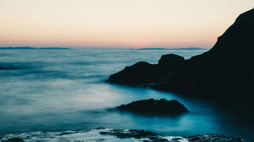 Scenic view of sea against clear sky during sunset