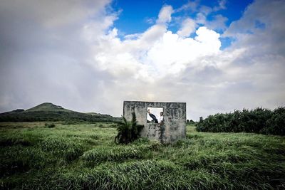 Built structure on landscape against sky