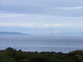 Scenic view of sea against cloudy sky