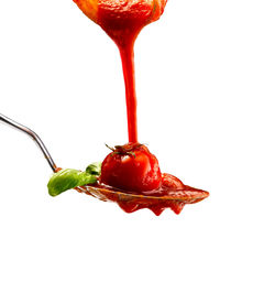 Close-up of red chili pepper against white background