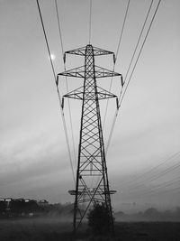 Low angle view of electricity pylon against sky