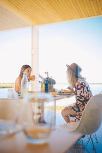 Friends having food while sitting in tourist resort