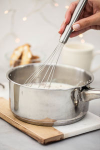 Cropped image of person preparing food in wok