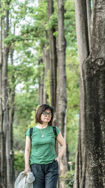 Young woman standing in forest