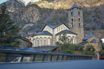 View of trees and buildings against mountain