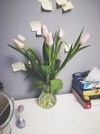 Close-up of roses in vase on table at home