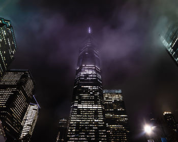 Low angle view of illuminated buildings against sky at night