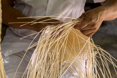 Midsection of person working in factory