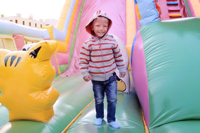 Portrait of smiling boy standing on bouncy castle