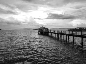 Pier over lake against sky