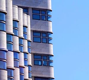 Low angle view of building against clear blue sky