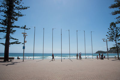 People on beach against sky