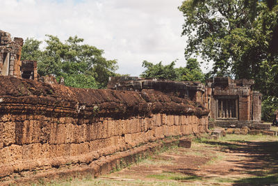 Old ruin and trees against sky