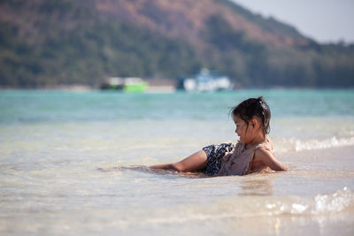 Girl lying in sea