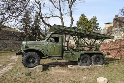 Abandoned truck on field against sky