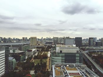 Cityscape against cloudy sky