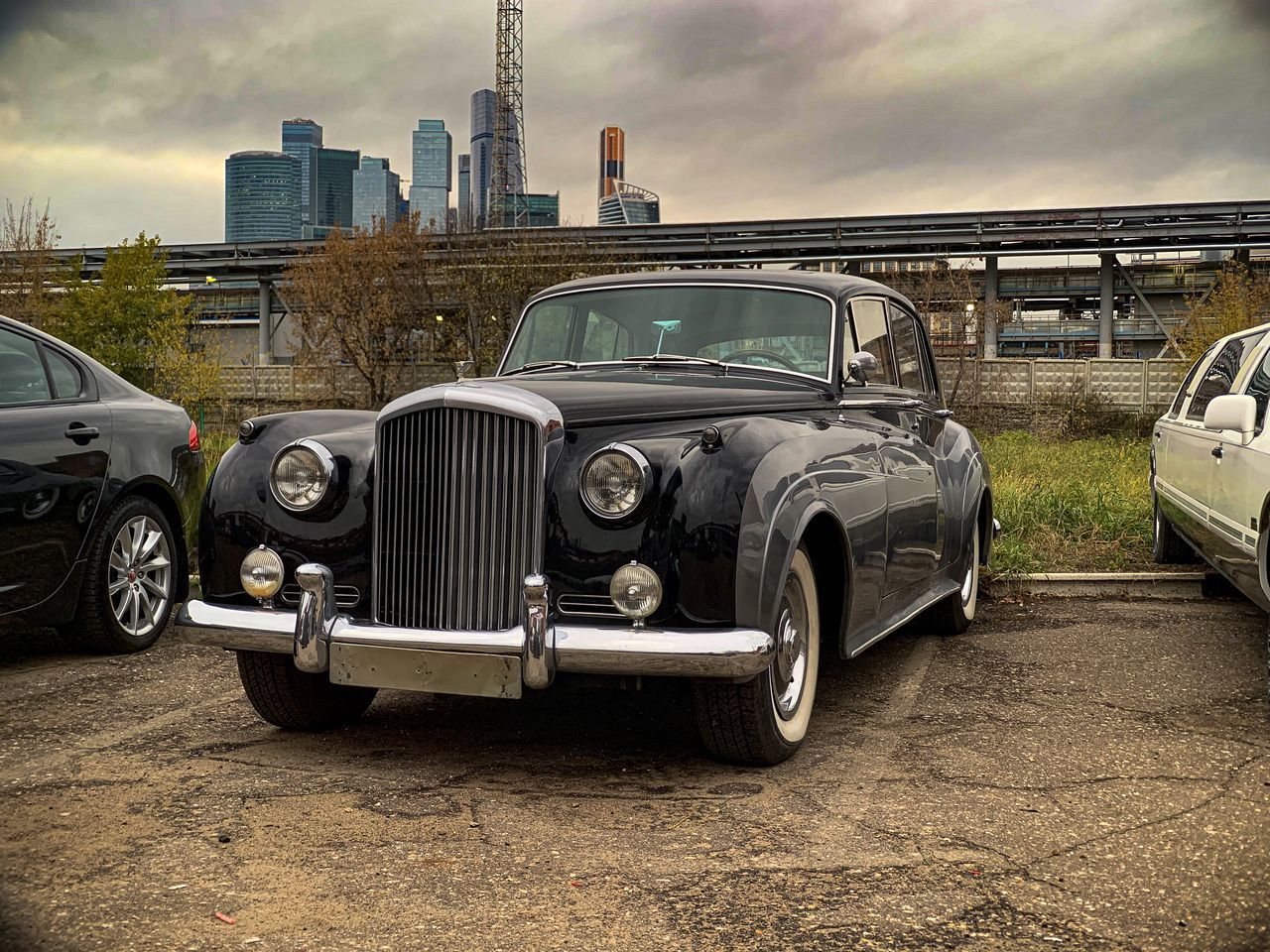 VINTAGE CAR ON BUILDING AGAINST SKY
