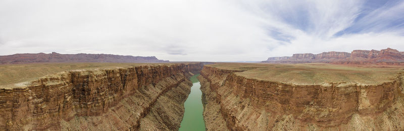 Aerial of the colorado river cutting a green line through the de