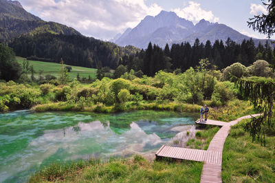 Scenic view of lake and mountains on sunny day