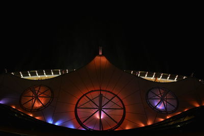 Low angle view of illuminated lights against clear sky at night