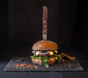 Antique cake on table against black background