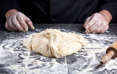 Midsection of chef preparing food at table