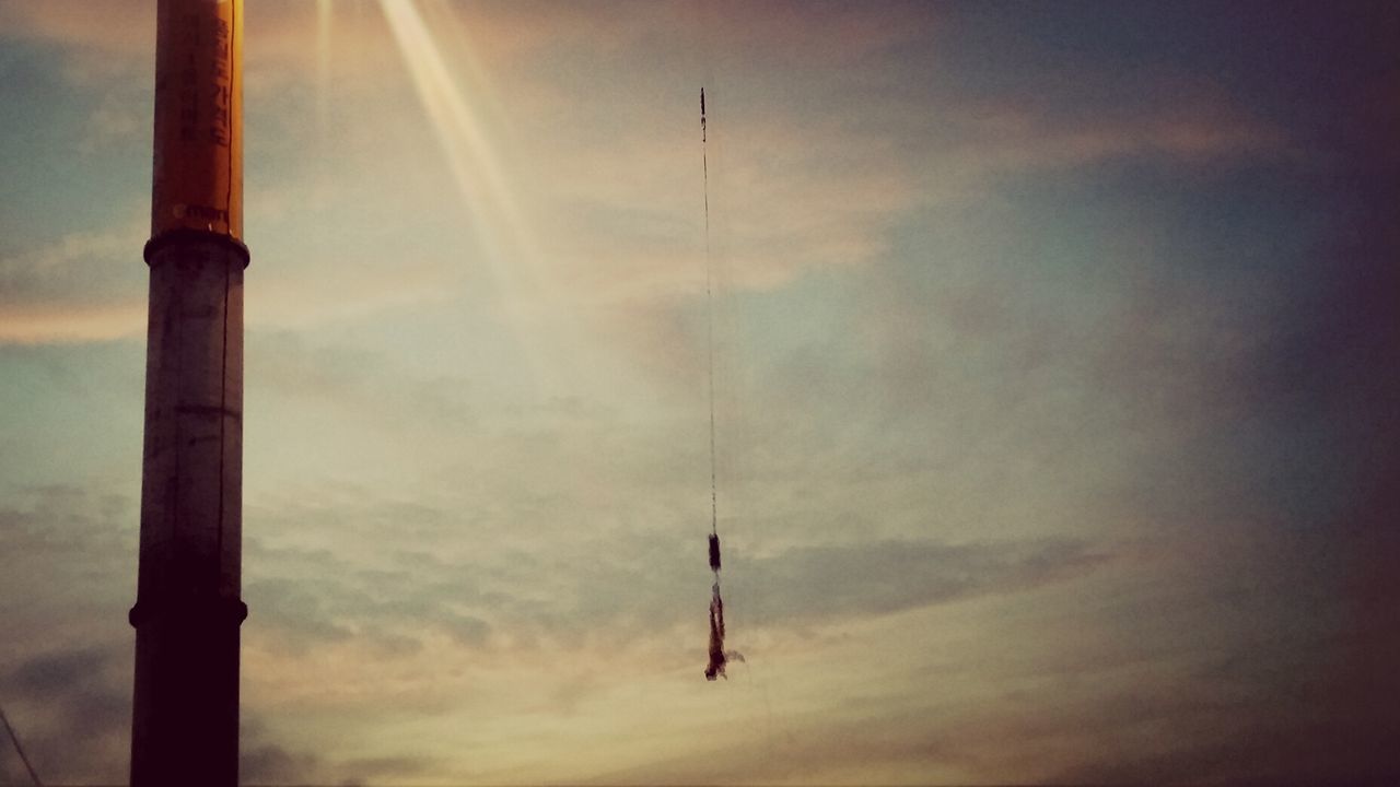 sky, sunset, flying, low angle view, silhouette, cloud - sky, scenics, tranquility, nature, mid-air, bird, beauty in nature, cloudy, tranquil scene, sun, outdoors, dusk, weather, airplane, cloud