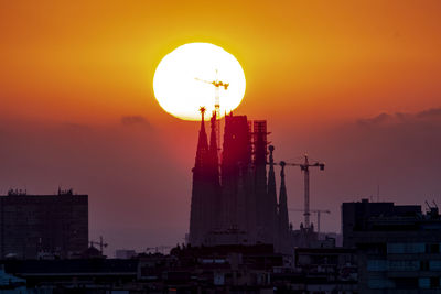 Low angle view of buildings against sky during sunset