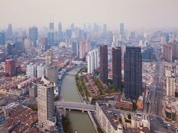 High angle view of modern buildings in city against sky