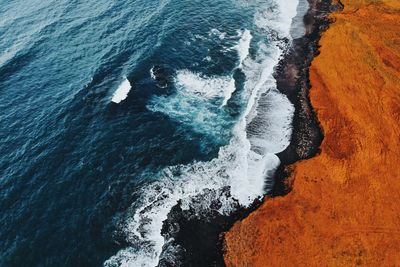 High angle view of waves breaking on shore