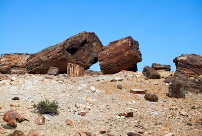 Built structure on sand against clear blue sky