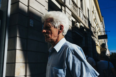 Portrait of man standing by building