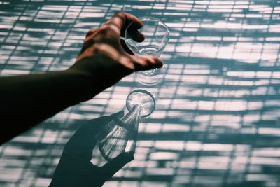 Shadow of person holding glass window