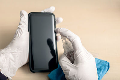 Midsection of person using mobile phone
